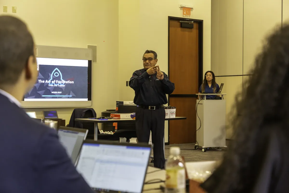 Moises Solis facilitating the Art of Facilitation Train the Trainer workshop for seated participants